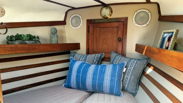 Striped cushions on the berth inside a boat