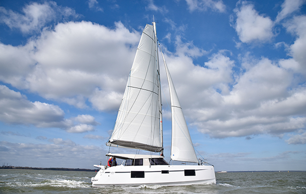 Multihull sailing with a white sail