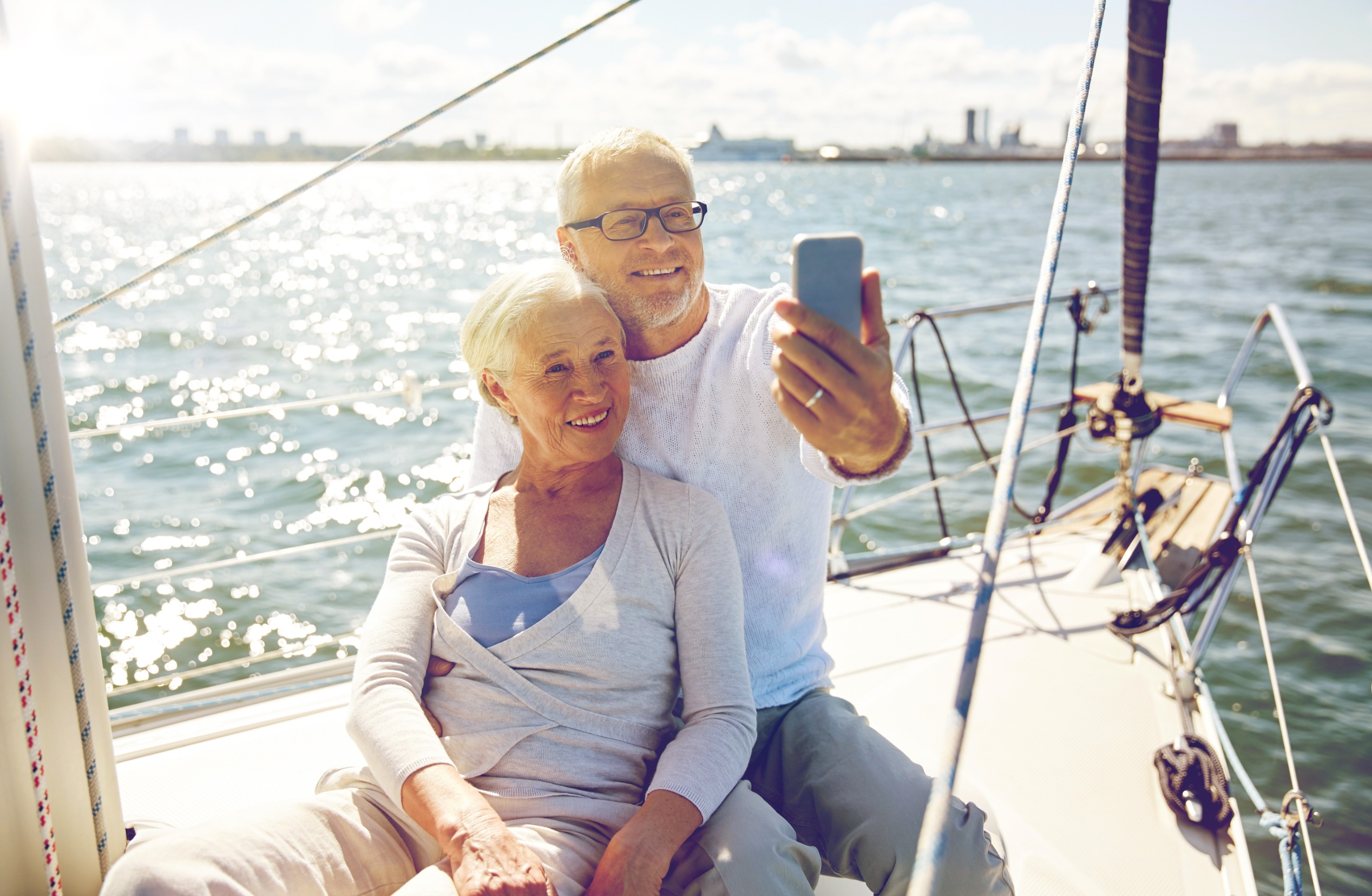 Older couple sat on a yacht while video calling